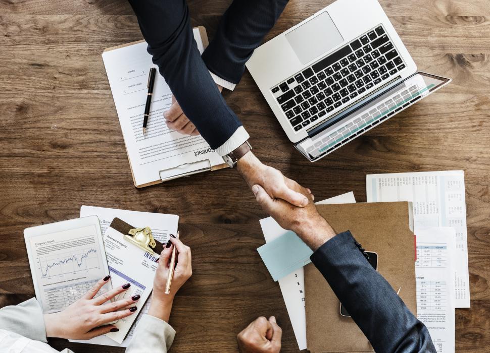 handshake between two businessmen on signing a contract handshake between two businessmen on signing a contract